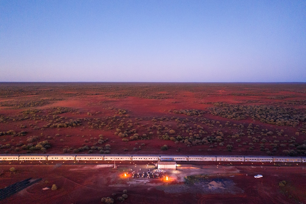 The Ghan crossing the red landscape near Marla
