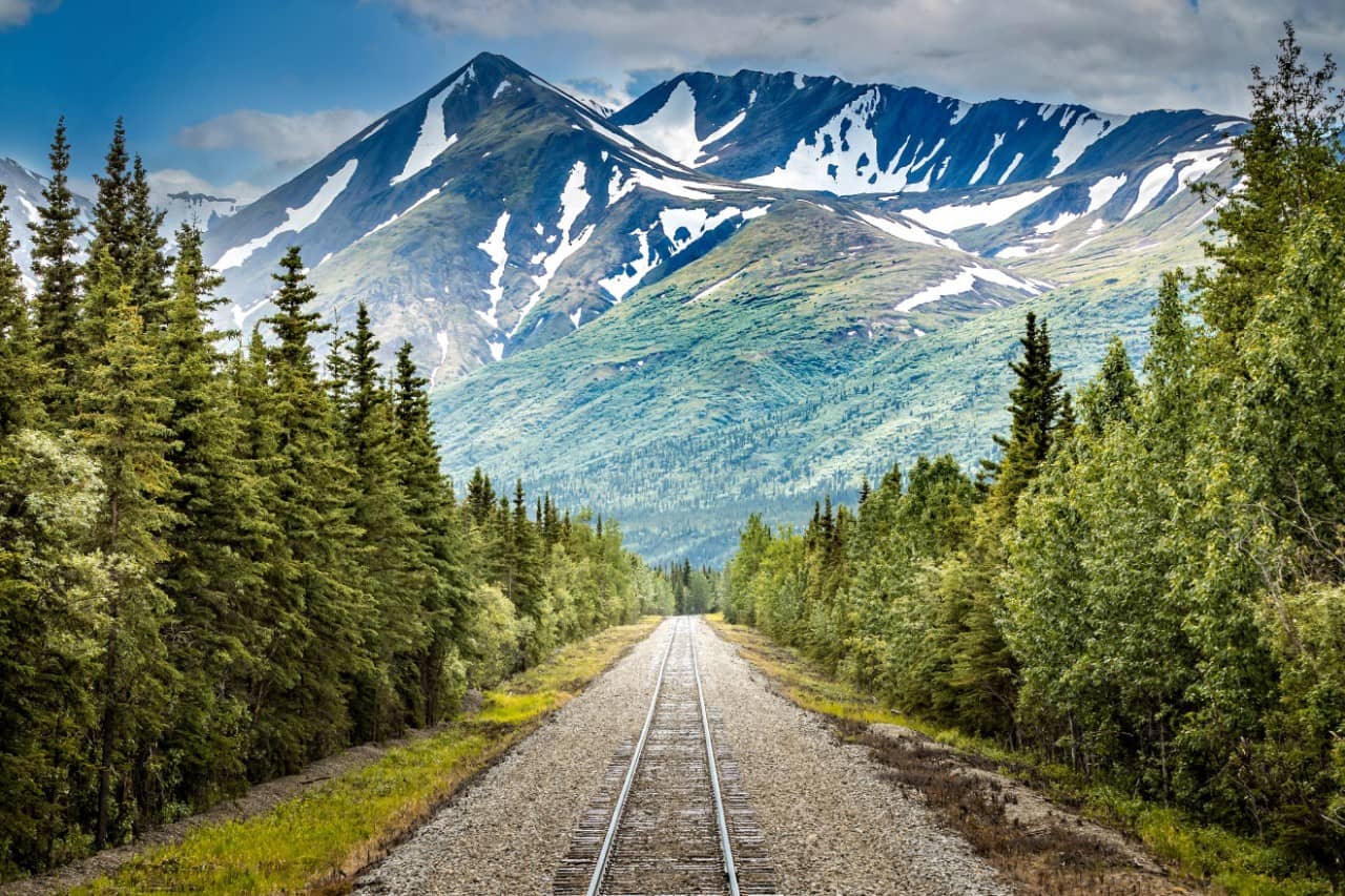 Alaska cruise travelers continuing inland aboard a scenic railcar