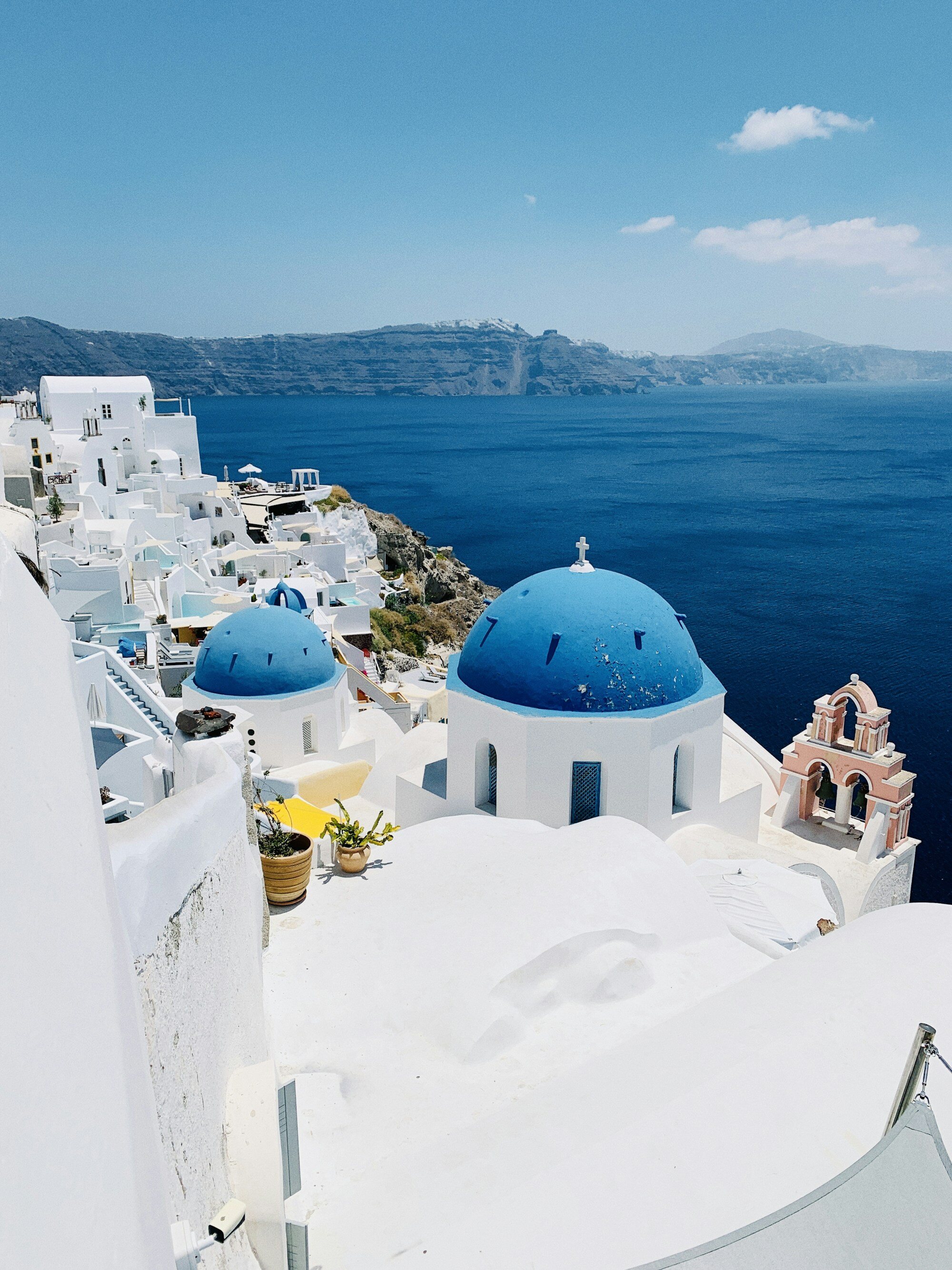 Whitewashed Santorini buildings above the blue Aegean Sea