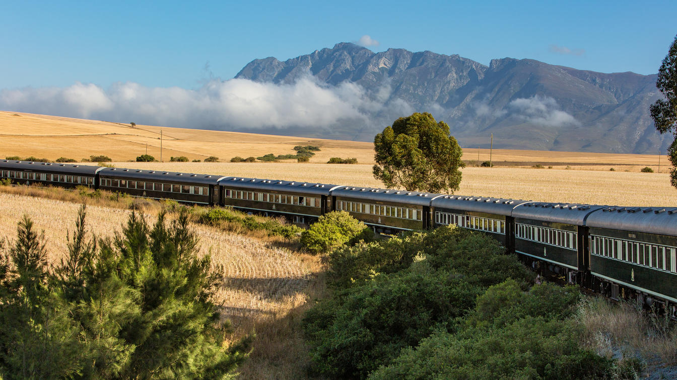 Authentic Rovos Rail traveling through Southern African mountain scenery
