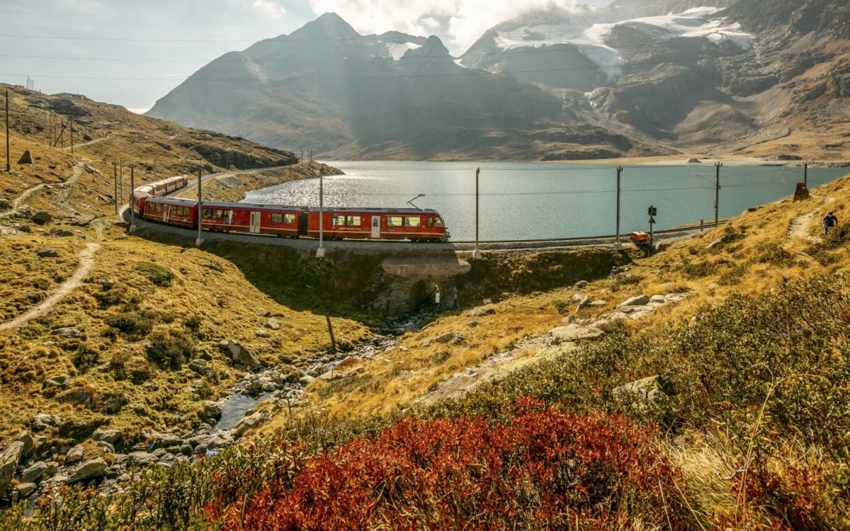 Rhaetian Railway train near Lago Bianco in Switzerland
